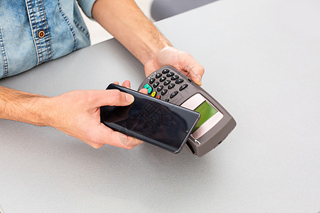 使用移动电话支付费用给NFC的客户读者互联网编辑信用通信交易技术商业顾客近场图片