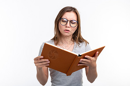 人与教育概念有吸引力的妇女以白人背景阅读一本书的白种背景女性头发极客女孩女士眼镜成人男性黑发笔记图片