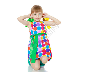 绿色裙子小仙子一个穿着多色环状花样的裙子的小女孩女性快乐女儿灰色工作室眼睛卷曲绿色公主幸福背景