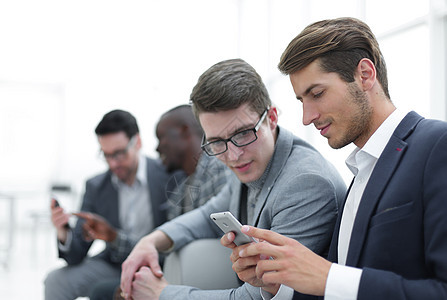 商业同事阅读智能手机短讯商务技术软垫顾问会议屏幕人士办公室男性成人图片