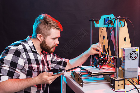 年轻男性设计师工程师在实验室使用 3D 打印机并研究产品原型 技术和创新概念项目科学电脑电子产品胡须研究员电气发明学校软件图片