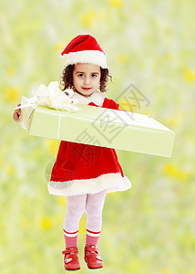 穿着圣诞老人礼服的小女孩 有礼物乐趣快乐帽子假期盒子季节孩子女孩童年展示图片