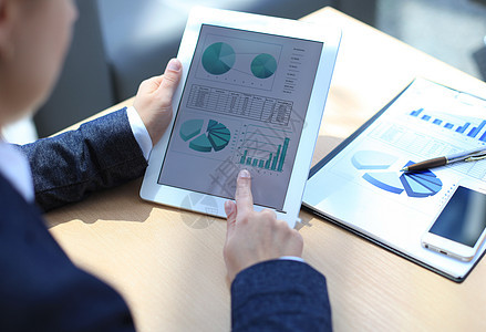 商务人员分析平板电脑屏幕上显示的财务统计数据公司上网经济金融互联网解决方案报告商业进步工人图片