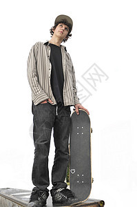 一个年轻男孩的肖像孩子滑板青少年溜冰者运动牛仔裤乐趣青年头发锻炼图片