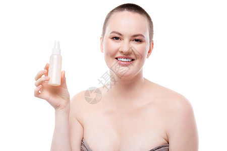 裸露肩膀和完美皮肤的美丽女子 展示了护肤产品温泉白色瓶子护理塑料身体女孩治疗女性图片