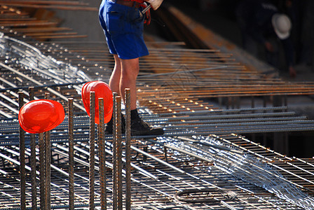 建筑工地的红色头盔交易杂工男性安全帽工作建设者工人建筑师男人脚手架图片