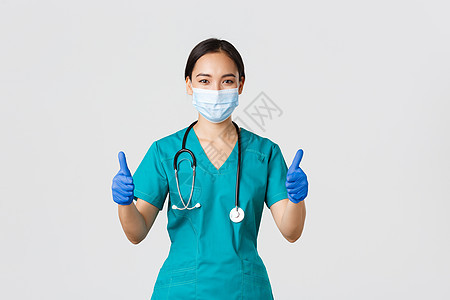 Covid19 冠状病毒病 医护人员的概念 自信的专业医生 个人防护设备的亚洲医生 保证和确保病人 在医用口罩中保持安全工人隔离图片