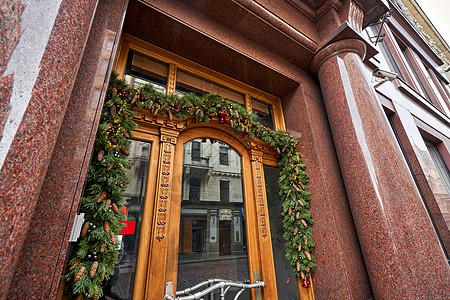 圣诞节早上 房子有装饰的门 还有圣诞花圈和树枝 欧洲街市 是的装饰品庆典城市场景礼物门廊寒假花圈幸福松树图片