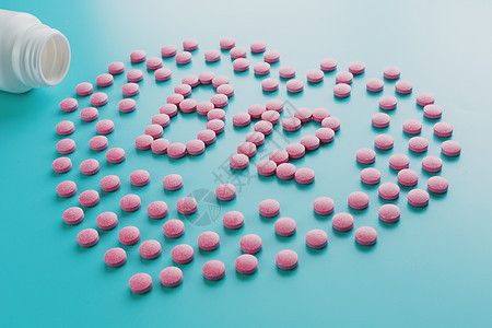 粉红平板 以B12的形式 在心脏中蓝色背景的B12 从白色溢出地面木头托盘健康药店制药愈合矿物字母剂量图片
