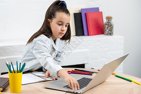 以笔记本电脑银式电脑为学生小学校女学生做家庭作业微笑键盘技术女孩课堂办公室瞳孔卷曲教育女性图片