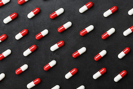 黑背景的红色和白色药丸胶囊模式 笑声制药科学治疗卫生止痛药医院处方宏观抗生素药店图片