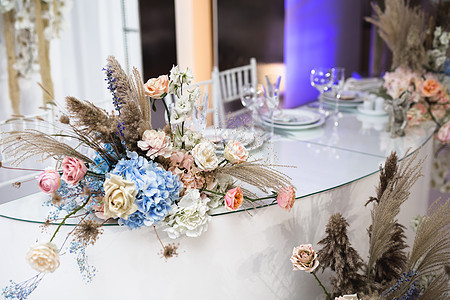 在一家用鲜花和干花制成的餐馆举行婚礼时装饰假期新娘木头蜡烛花艺庆典玫瑰客人婚姻桌布图片