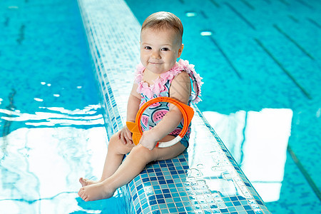 小女孩在游泳池上游泳课时 在泳池里大笑情感喜悦假期家庭享受运动新生游泳者孩子玩具图片