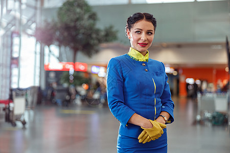 站在机场终端站的女空姐或空姐手套旅行工作职业航空公司服务员微笑工人女性航空图片