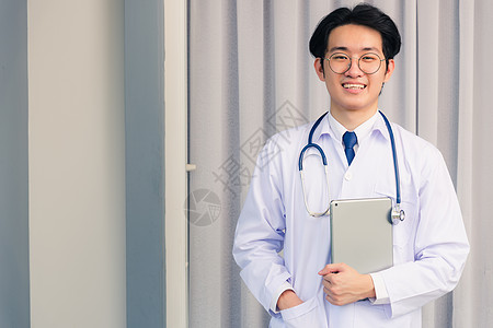 医生男人微笑着穿着制服和听诊器的脖子颈部 手持带平板电脑图片