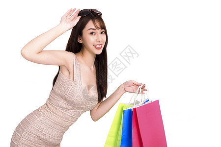 抱着购物袋的快乐青年妇女购物者消费者女士零售微笑乐趣折扣购物中心女孩销售图片