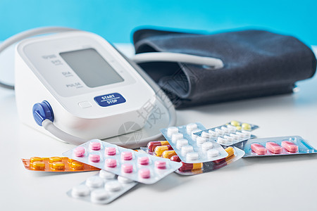 白桌上的数字血压监测器和医疗药丸 保健与医药概念在白色桌子上病人监视器测试药剂药片脉冲测量制药高血压抗生素图片