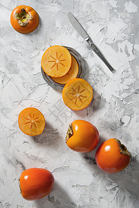 双西蒙切片位于灰色背景上 以六边形瓷砖的形式出现情调饮食营养季节宏观柿子水果小吃异国橙子图片