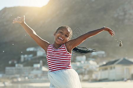 夏默士终于来了 一个可爱小女孩在海滩玩得开心的肖像图片