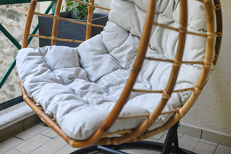阳台上挂着灰色坐垫的竹子椅子图片