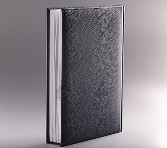黑皮笔记本或灰色背景日记图片