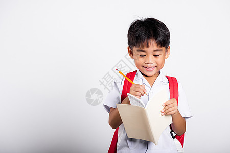 带着铅笔写笔笔记本的学生穿着校服红裤子红色裤写作青少年女学生瞳孔家庭作业演讲学习童年幼儿园教育图片