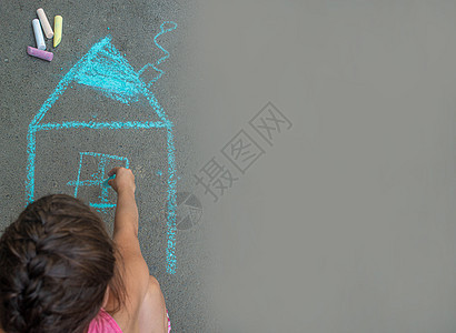 孩子用沥青上的粉笔画房子 有选择的焦点派对横幅女士绘画喜悦女孩乐趣粉笔创造力艺术图片