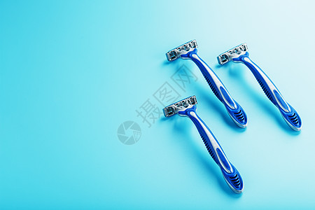 蓝剃须机在蓝色背景上排成一排 带冰块沙龙化妆品刀刃安全男性头发奢华身体洗手间塑料图片