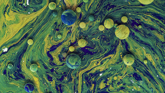 空间蓝色背景上的黄色 绿色气泡假期墨水魔法条纹辉光薄雾粒子艺术液体大理石图片