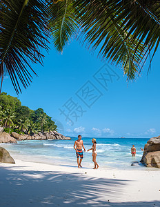 年轻夫妇男女在塞舌尔的豪华假期期间在热带海滩上 热带海滩 塞舌尔拉迪格岛旅行异国椰子蜜月夫妻快乐享受太阳蓝色奢华图片