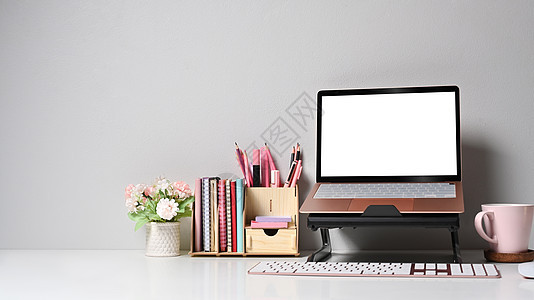 配备电脑笔记本电脑 花盆和白桌上咖啡杯的家办公桌图片