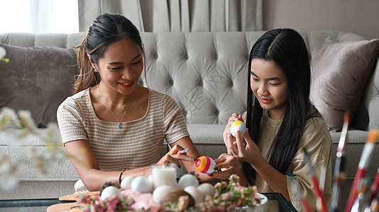 美丽的亚洲母亲和她的女儿一起庆祝复活节 一起画鸡蛋 复活节假期的概念乐趣染色画笔创造力客厅成人假期艺术女性女孩图片
