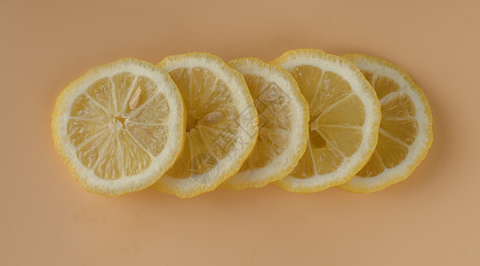 柠檬片 柠檬片 在孤立的杏子颜色背景上切成片片阴影热带水果果汁团体宏观食物横截面柠檬小吃图片