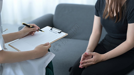 专业医生穿白色大衣与病人交谈 在诊所预约值诊时签署医疗文件 (单位 千美元)图片