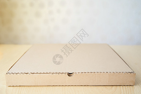 桌子上孤立的棕色纸板披萨纸盒运输包装贮存商业披萨盒送货正方形瓦楞案件办公室图片