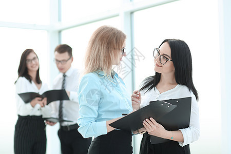 签署商业文件的女商务人士 在办公室中站着图片