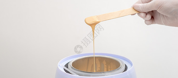木制烟斗上带热蜡的轴加热器液体化妆品沙龙程序水疗温度身体温泉卫生护理图片