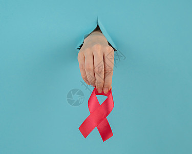 女人用红弓棒从蓝底的洞里伸出手 乳癌象征物癌症结核卫生治愈感染歧视捐款心血管控制药品图片