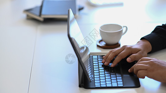 年轻商务人士在白色办公桌用电脑平板电脑工作办公室高清图片素材