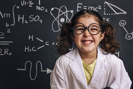 穿着实验室大衣的有趣的小女孩科学学生背景图片