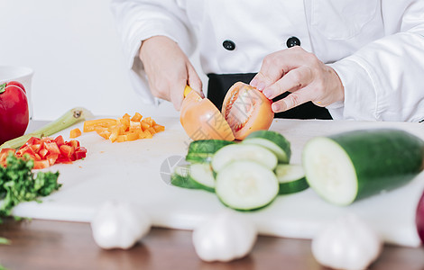厨师女手切西红柿和蔬菜的特写 厨师手准备和切蔬菜 女厨师手切西红柿和蔬菜图片