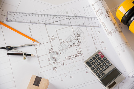 在建筑办公室办公桌桌上有修理工具的房主计划蓝图文件最顶级浏览器电脑建筑师计算器笔记本铅笔职场地面文档草图技术图片