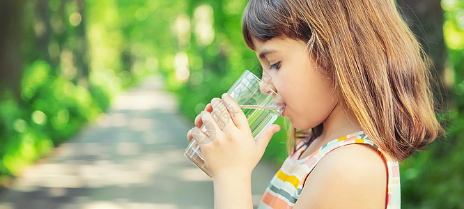 一个孩子喝着水 从杯子里取出自然 选择性的焦点婴儿居住乡村微笑嘴唇幸福生活食物横幅女孩图片