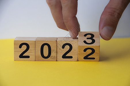 重启2023年快乐新年符号 手把立方体从2022年变成2023年 复制空间 新年概念庆典战略季节居住数字成功时间保险假期商业背景
