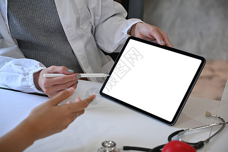 使用数字平板电脑和向病人提供建议 近距离观察穿白色医疗制服的白体医生图片