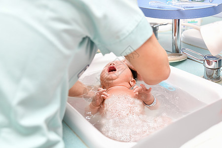 护士为新生儿第一次洗澡提供护士服务图片
