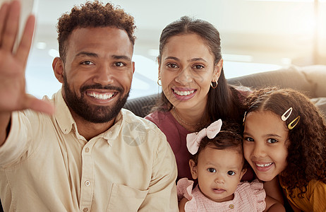 微笑的混血父母与可爱的女儿自拍的画像 快乐的西班牙裔家庭在家里为社交媒体拍照 妈妈 爸爸和小女孩在拍照时亲密无间图片