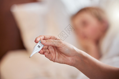 这个温度降不下来 一个面目全非的女人在家里的床上用温度计给小女孩量体温图片