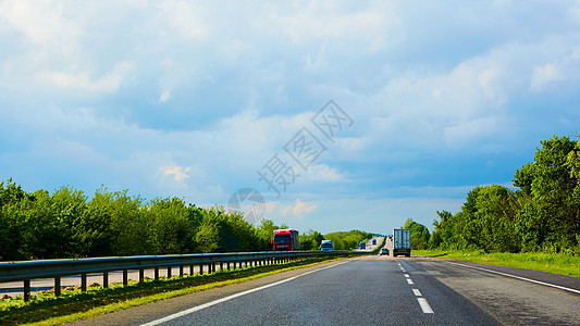 暴风雨前日落时的高速公路交通沥青蓝色农村天空太阳曲线场景运动街道车辆图片