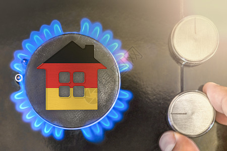 德国的供暖季节或天然气使用 概念 房子的模型站在黑色背景上的燃气锅炉的火焰附近 在德国使用天然气的成本图片